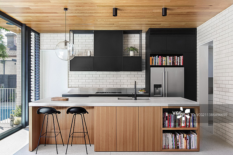 窗前带木质和黑色门面的开放式厨房图片素材