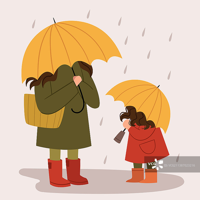 妈妈和女儿拿着黄色雨伞走在图片素材