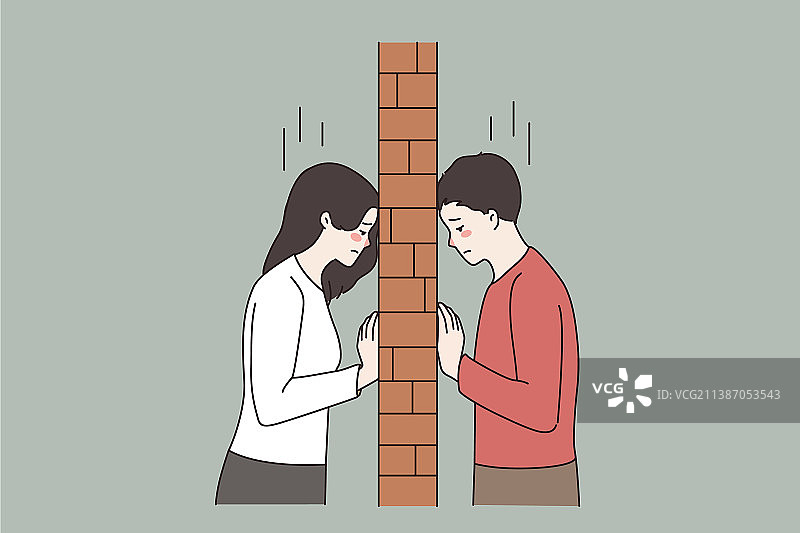 争吵中被砖墙隔开的不快乐夫妇图片素材