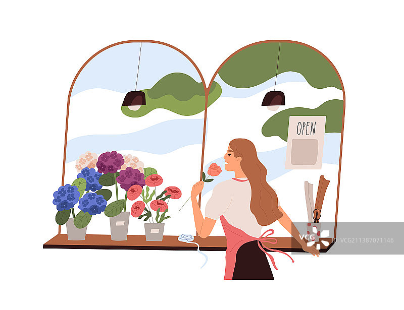 花店里闻鲜花的女人图片素材