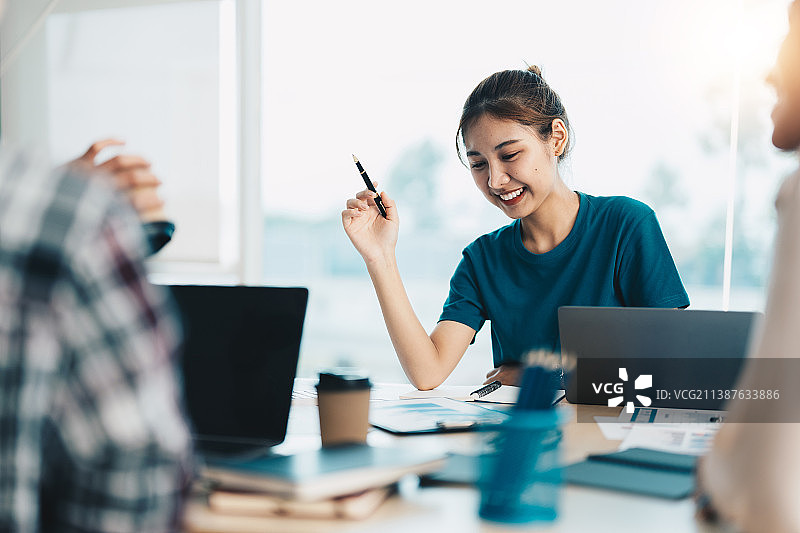 一群快乐的亚洲年轻创业者在洽谈业务图片素材