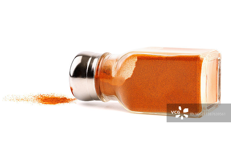 倾倒的玻璃胡椒罐和红辣椒粉图片素材