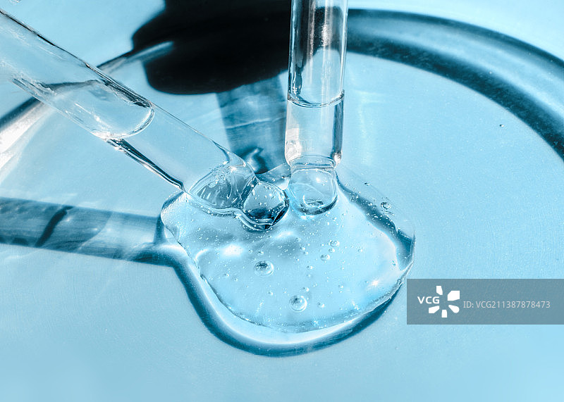 玻璃培养皿中盛放的两支滴管，内含精华液、精油和洁面啫喱图片素材