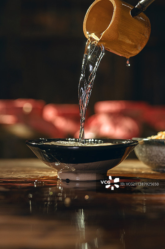 木勺里的酒倒入碗中图片素材