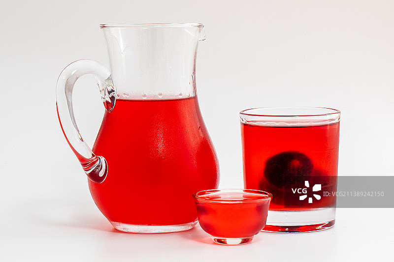 盛放冰镇杨梅酒的分酒器和酒杯图片素材