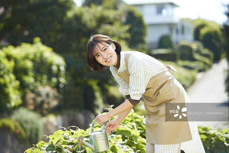 日本女人在花园工作图片素材