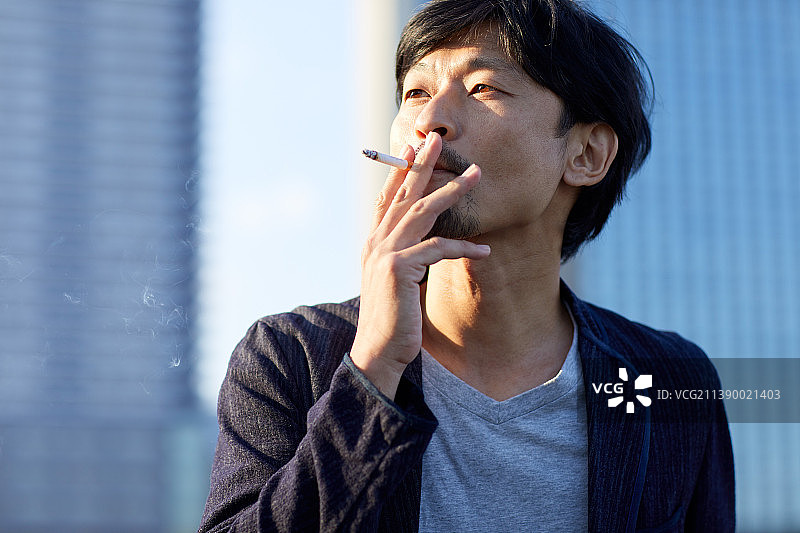 在室外吸烟的日本男人图片素材