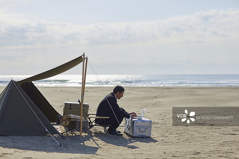 在海滩工作的日本商人图片素材