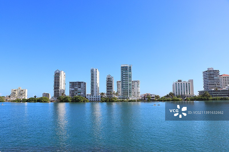 建筑旁河流的风景，晴朗的蓝天图片素材