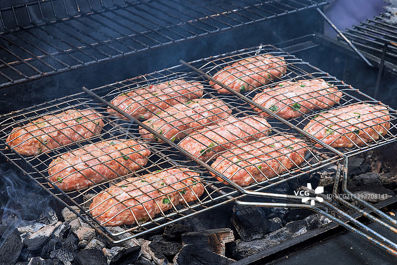 热烤架上混合的美式烧烤食品，包括汉堡和牛肉图片素材