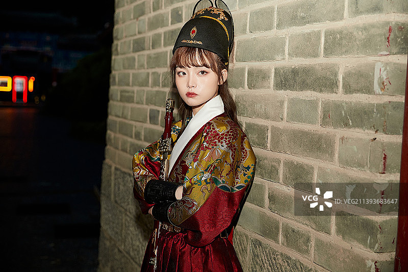 身穿锦衣卫飞鱼服手持宝剑的东方美少女图片素材