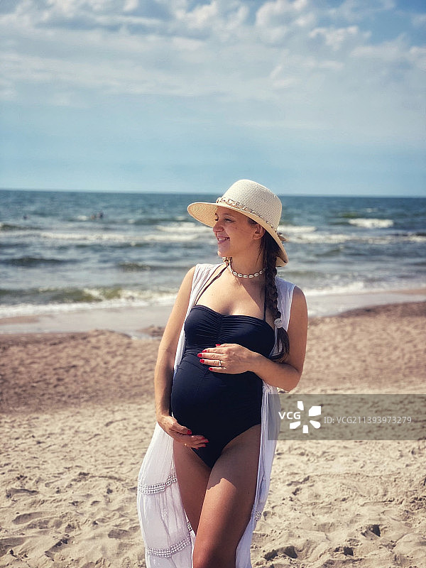 在海滩上的年轻孕妇图片素材