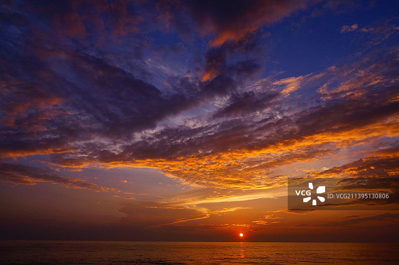 日落时大海映衬着壮观的天空的风景图片素材
