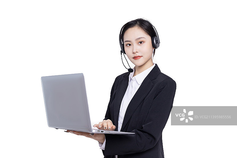 年轻女性客服带着耳麦使用电脑工作图片素材