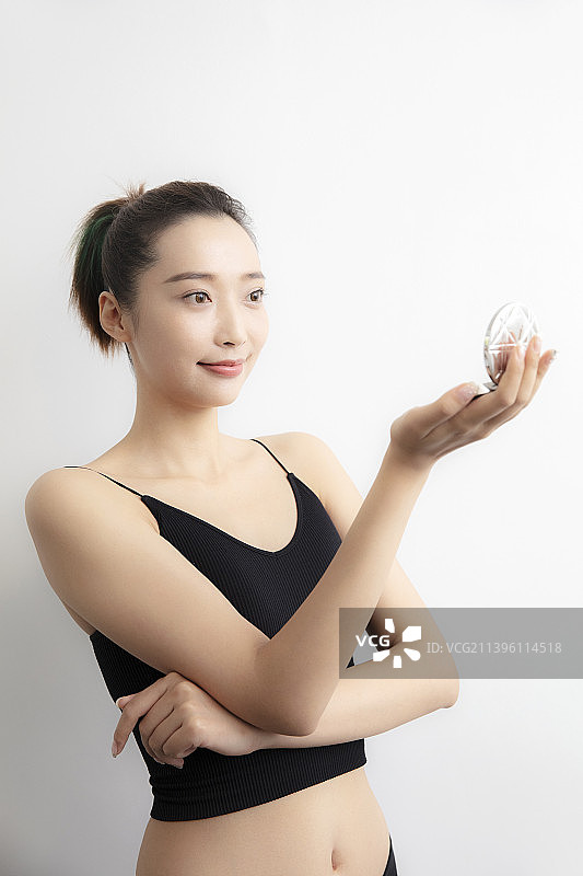 补妆照镜子的年轻女士图片素材