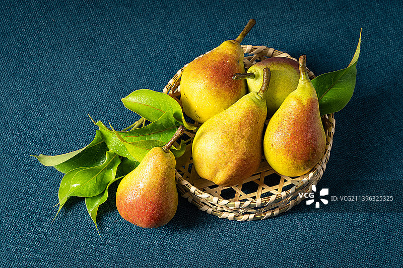 蓝色背景下的新鲜茄梨图片素材