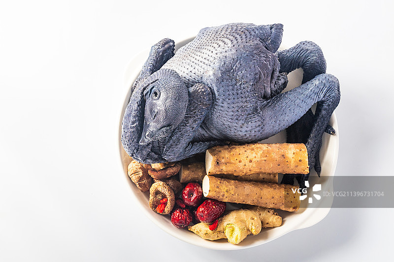 白色瓷盘里放着一只乌鸡和配料食材图片素材