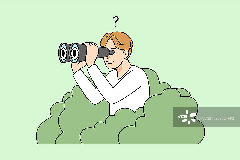 男人从灌木丛中用双筒望远镜观察图片素材