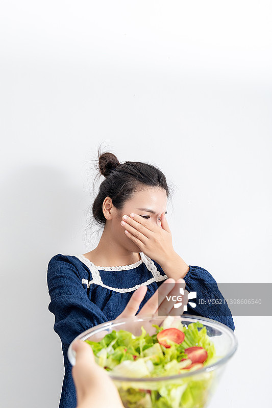 室内一名中国美女拒绝吃沙拉图片素材