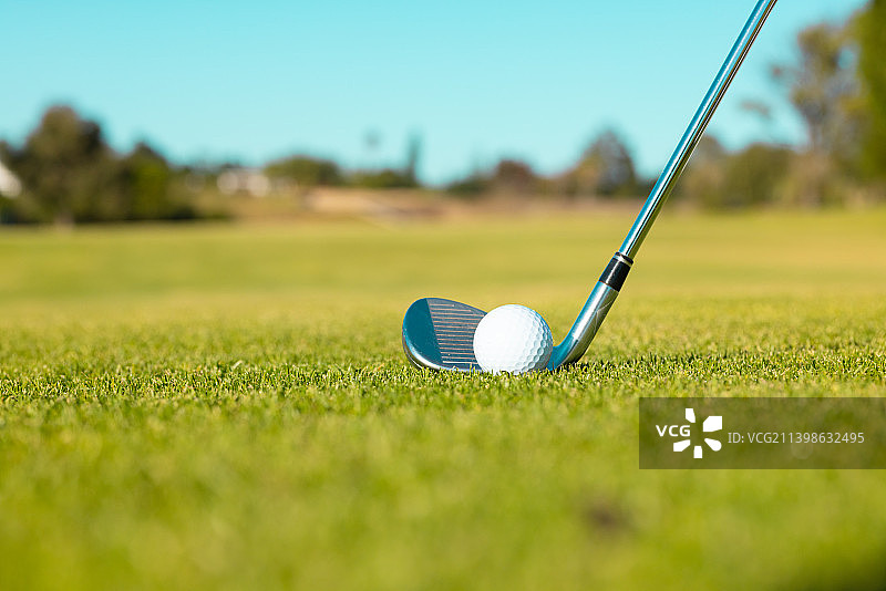 高尔夫球和球杆在夏季草地上的特写图片素材
