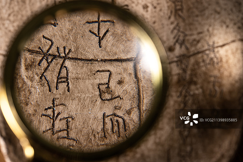 放大镜中甲骨文文物考古研究图片素材