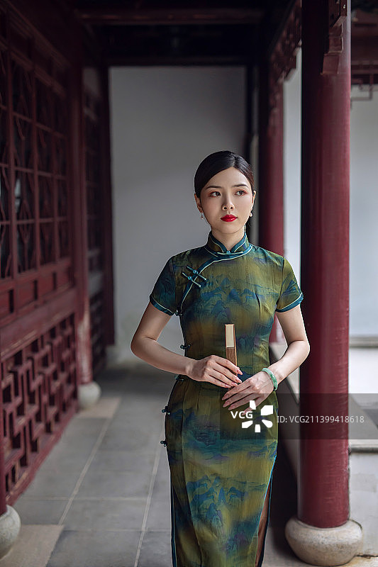 一个穿着旗袍的古典美人手拿折扇图片素材