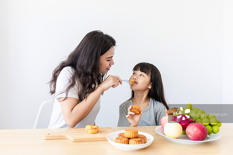 妈妈和女儿在家吃中秋节美食图片素材