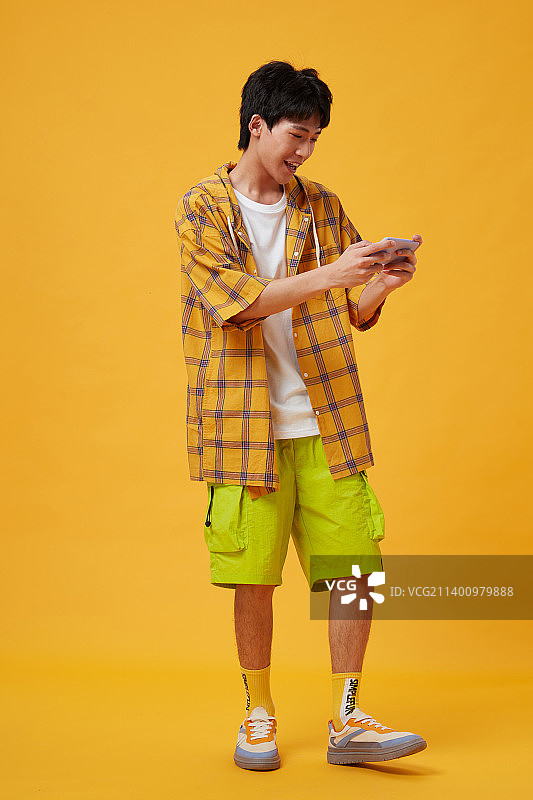 手拿手机的年轻男孩图片素材