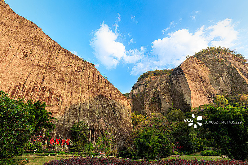 夏日傍晚夕阳照耀下的武夷山天游峰仙掌峰岩壁，摩崖石刻壁立万仞四字红书，丹霞地貌如刀劈斧刀，雄伟壮观图片素材