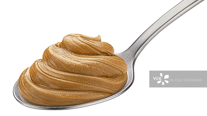 白色背景上的勺子里的花生酱图片素材