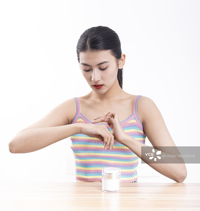 白色背景下穿着条纹吊带的美丽女性美容护肤图片素材