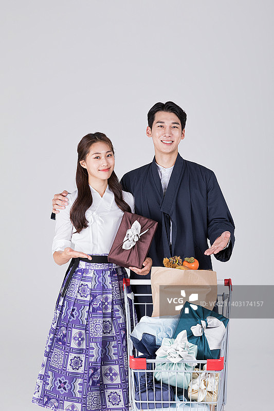 韩国情侣：身穿现代韩服的20多岁青年男女，推着购物车图片素材