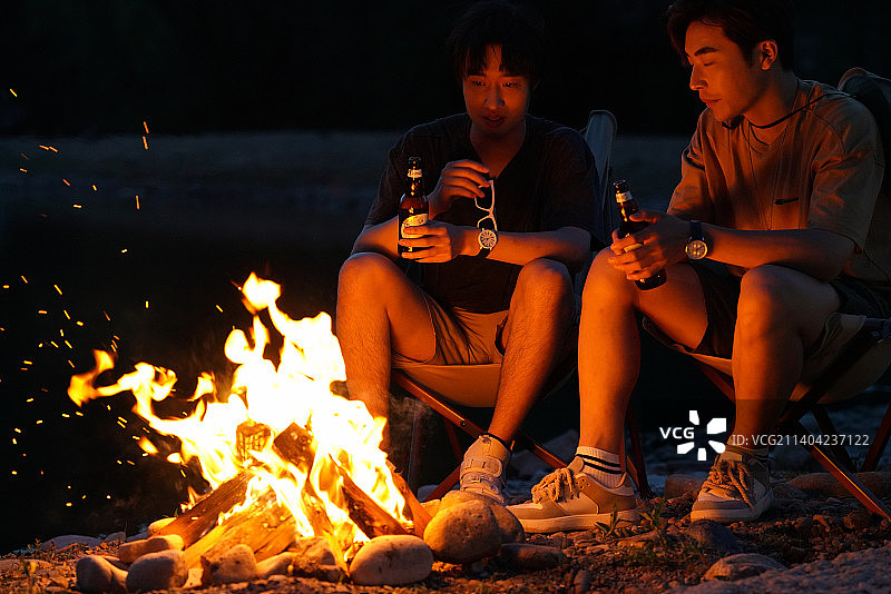 年轻人夜晚在野外篝火露营图片素材