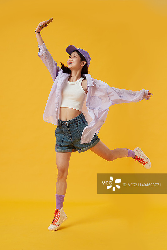 手拿手机兴高采烈的女孩图片素材