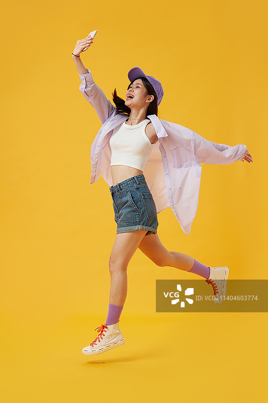 手拿手机兴高采烈的女孩图片素材