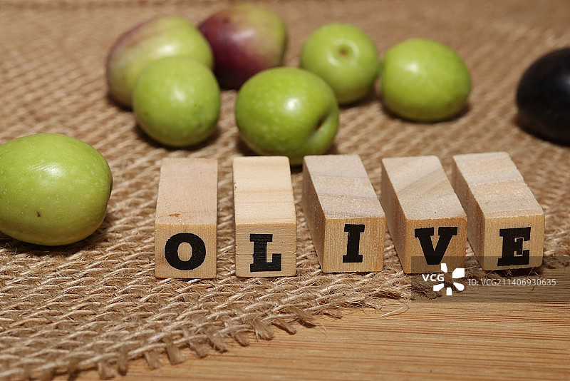 木制背景上的橄榄和橄榄油图片素材