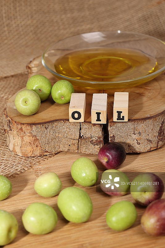 木制背景上的橄榄和橄榄油图片素材