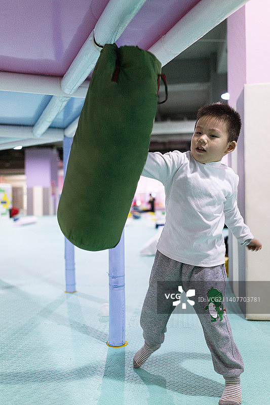 打沙袋的小男孩图片素材