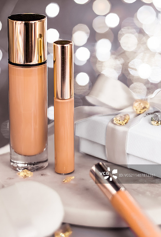 节日彩妆粉底液、遮瑕膏和白色礼盒图片素材