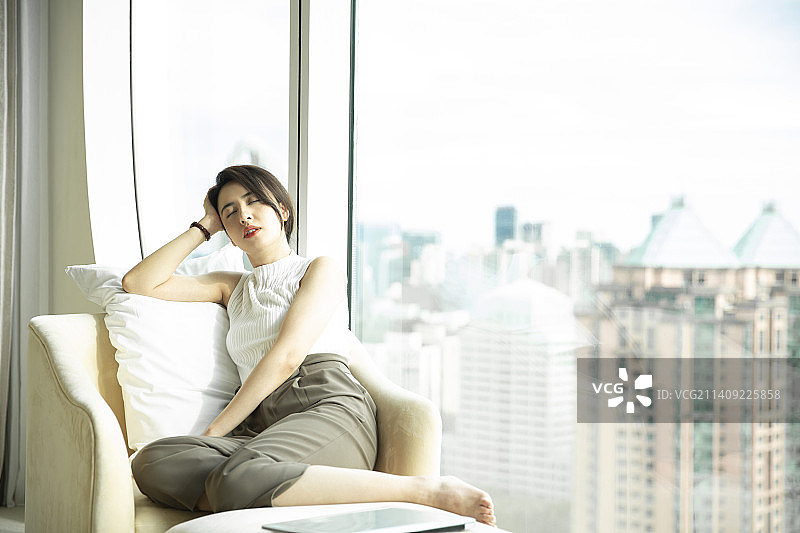 疲惫的商务女子在酒店房间工作后休息睡觉图片素材