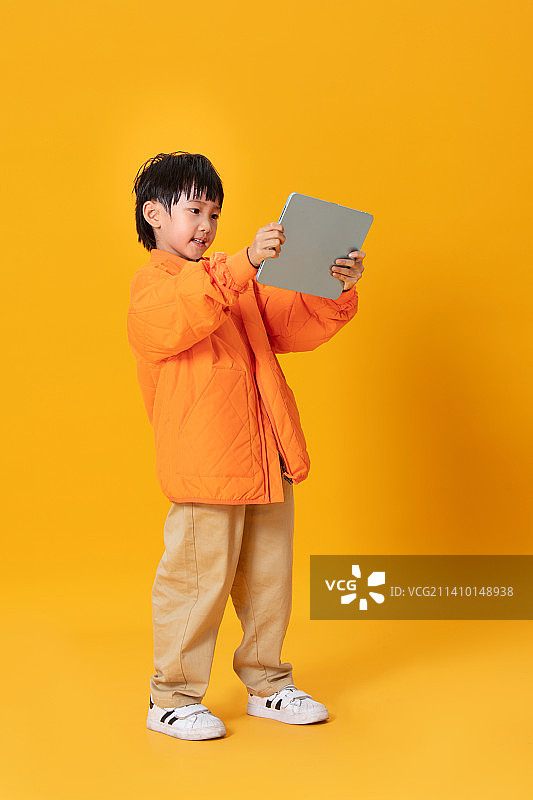 手拿平板电脑的小男孩图片素材
