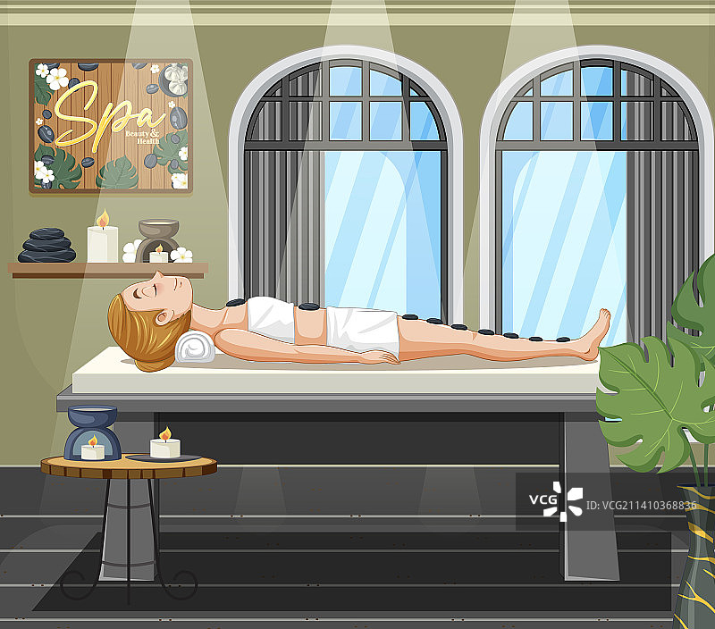 女人在水疗馆接受热石按摩图片素材