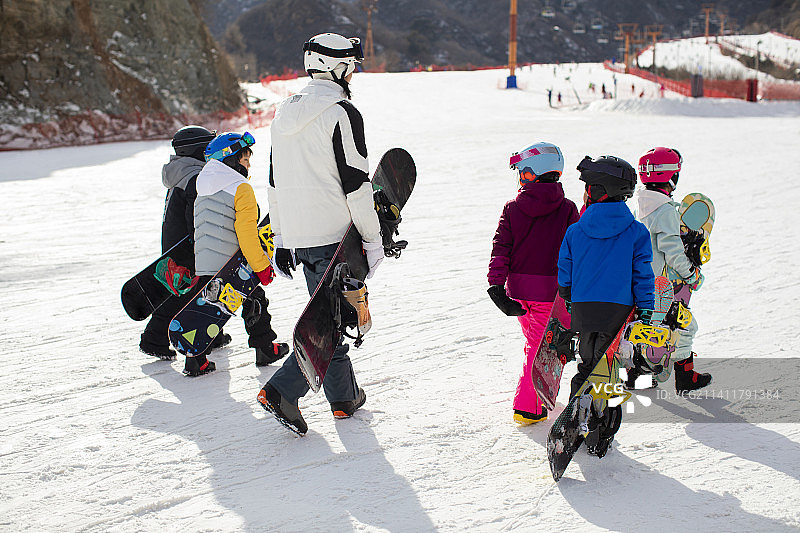 孩子们跟着教练在户外学滑雪图片素材