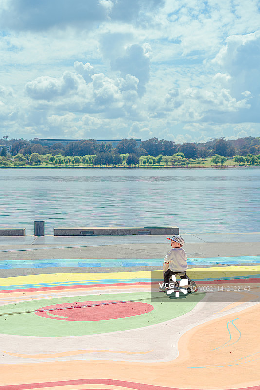 湖畔彩虹广场的平衡车男孩图片素材