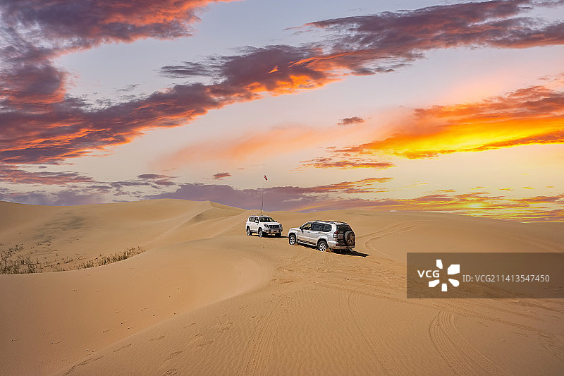 晚霞中的沙漠和四驱越野车图片素材