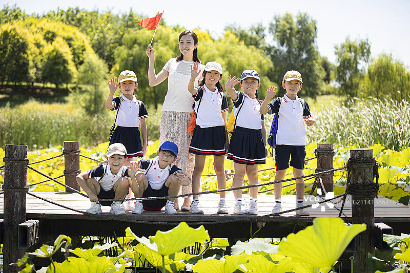 快乐的老师带领小学生春游图片素材
