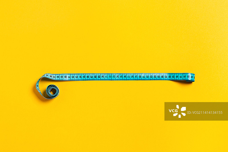 饮食理念，黄色背景上的卷尺图片素材