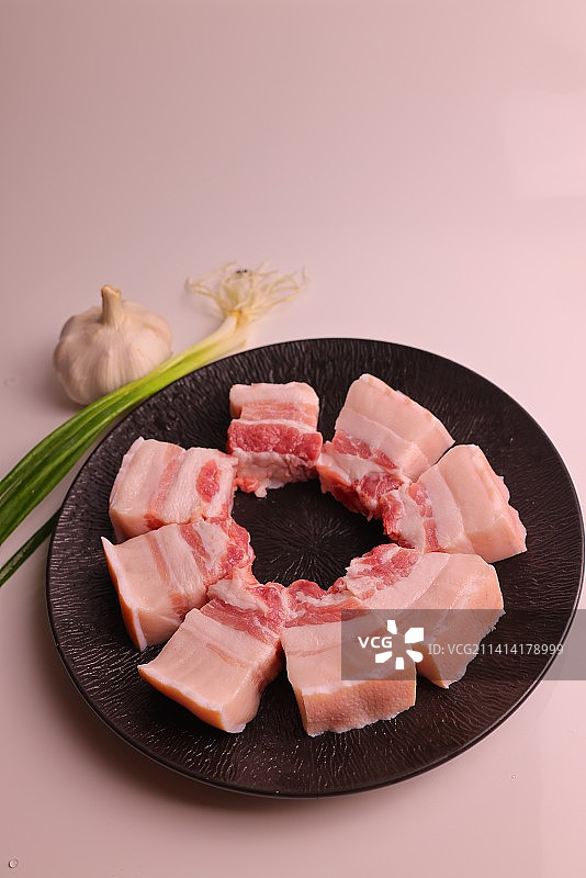 桌上盘子里的五花肉的特写镜头图片素材