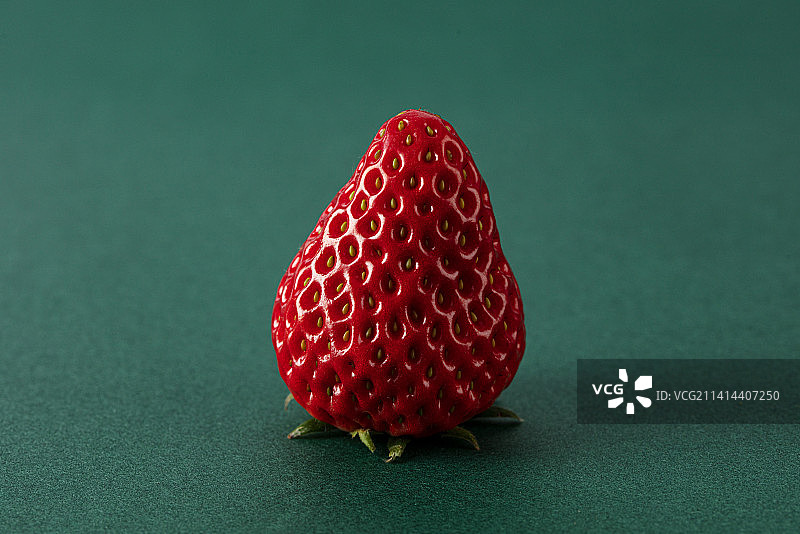 新鲜的草莓孤立在绿色背景上图片素材
