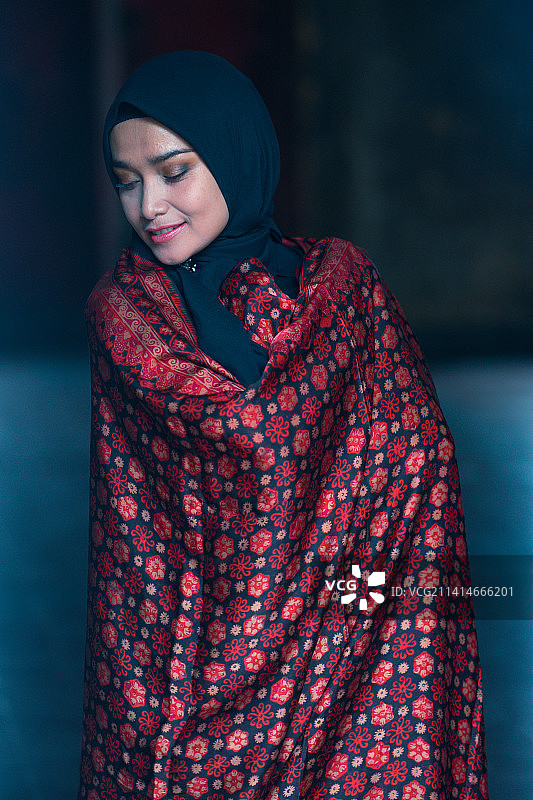 戴着印尼占碑、雅加达巴迪克头巾的黑衣美丽女人图片素材